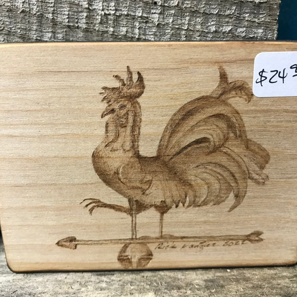 Wood burned rooster on arrow.