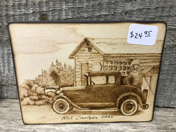 Wood burned antique vehicle in front of store. 