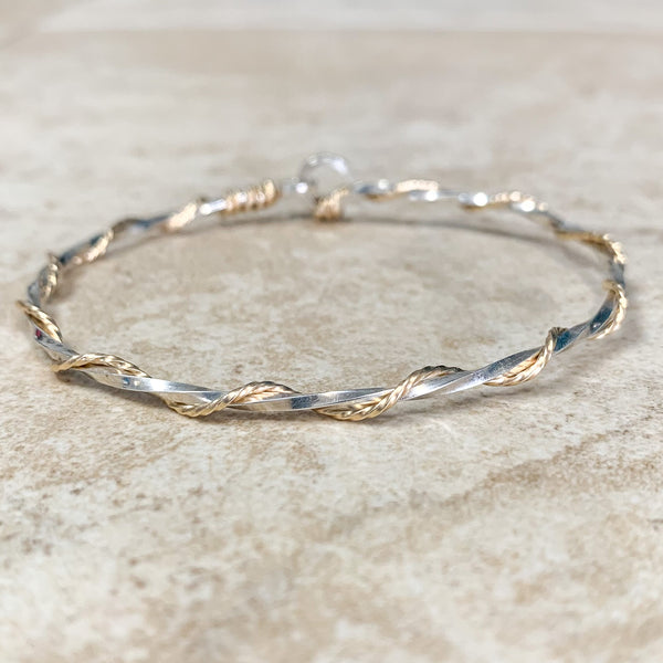 Bracelet:  A sterling silver twisted strand with a 14k gold strand twisted around the silver strand. Hook clasp.