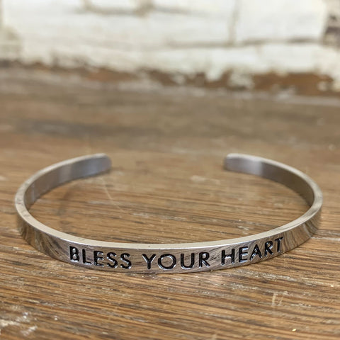 Bracelet: Silver cuff bangle bracelet with "BLESS YOUR HEART" engraved in black.