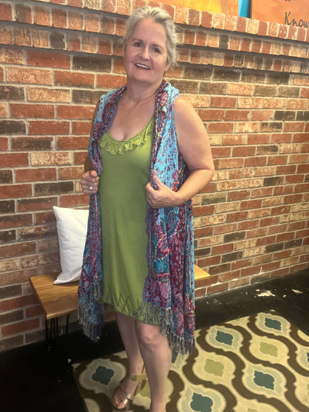 Knee Length Green Racer Back Dress with embroidery around the bottom.