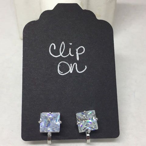 Earrings: Silver clip on with crystal cube.