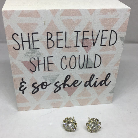 Pierced silver stud earrings with round crystal stone and outlined with small crystal squares. 