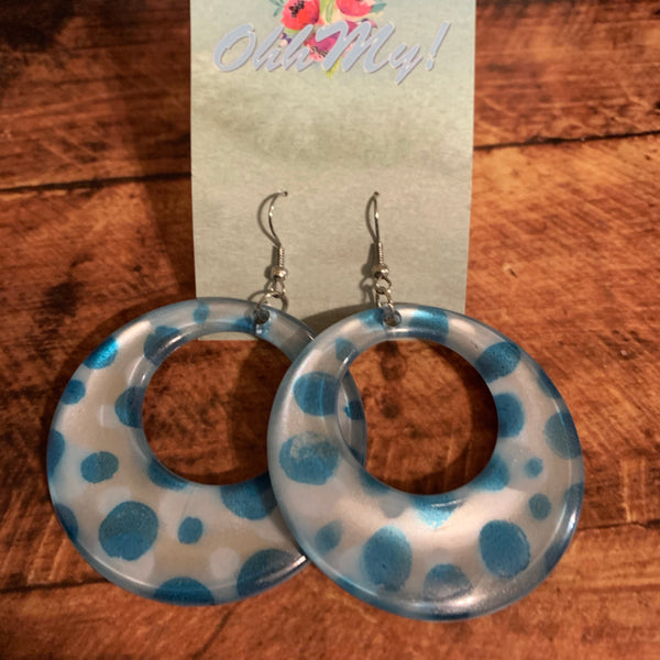 Pierced silver hook earrings: Hoop earrings with white background and blue polka dots.