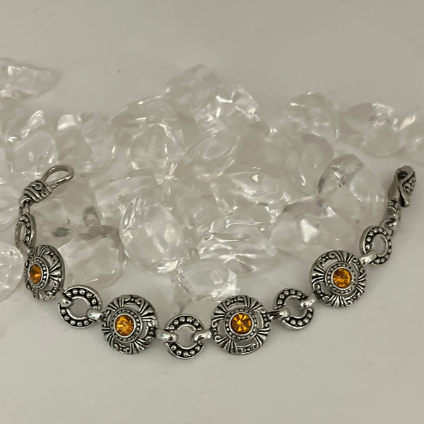 Silver Bracelet with decorative black background. Amber Color Stone in every other piece, Magnetic Closure Bracelet