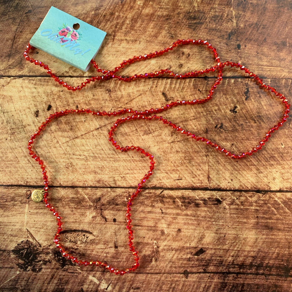 Necklace: Long stand with red faceted beads.